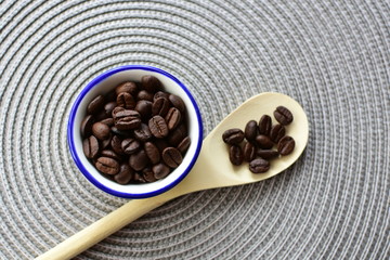 Colombian coffee beans, displayed in containers and spoons