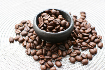 Colombian coffee beans, displayed in containers on black background