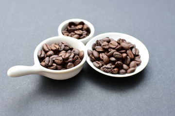 Colombian coffee beans, displayed in containers on black background