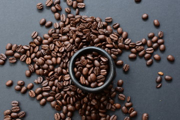 Colombian coffee beans, displayed in containers on black background