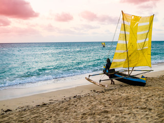 Colored outrigger fishermen pirogue leaves Anakao coast at sunset for a night fishing trip, Indian Ocean, Madagascar