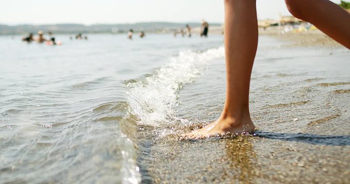 female feet step on the sea