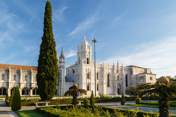 Fototapeta premium View of a park and the historic Mosteiro dos Jeronimos (Jeronimos Monastery) in Belem, Lisbon, Portugal, on a sunny morning.