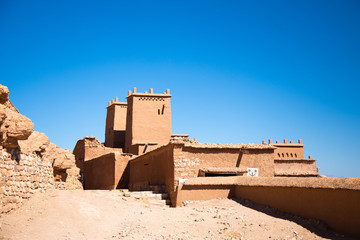 Ancient sand castle lays under the hill with blue sky background