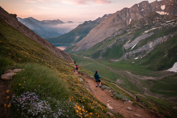 Fototapeta na wymiar people climbing up a mountain during sunrise