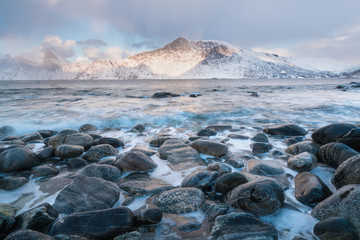 Panorama of snowy fjords and mountain range, Senja, Norway Amazing Norway nature seascape popular tourist attraction. Best famous travel locations. beautiful sunset within the amazing winter landscape
