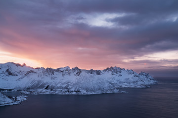 Fototapeta na wymiar Panorama of snowy fjords and mountain range, Senja, Norway Amazing Norway nature seascape popular tourist attraction. Best famous travel locations. beautiful sunset within the amazing winter landscape