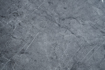 Gray scratched stone texture on background