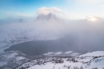Naklejka na ściany i meble Panorama of snowy fjords and mountain range, Senja, Norway Amazing Norway nature seascape popular tourist attraction. Best famous travel locations. beautiful sunset within the amazing winter landscape