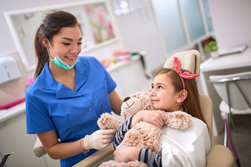 Dentist and female patient in dental chair