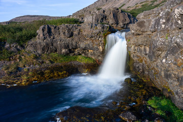 Obraz premium Iceland waterfall closeup view of the gods cliff with long exposure smooth motion of water in summer landscape