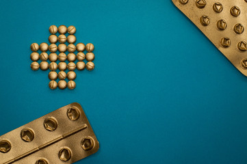 pills in cross shape and blisters on blue background - 328930761