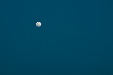 Full moon against the dark blue and black sky