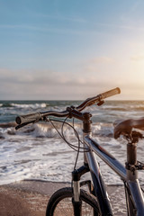 Fototapeta premium Bicycle stands by the sea while walking in the fresh air. Summer evening . Active lif