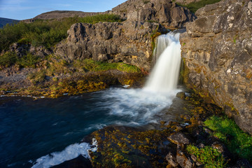 Naklejka na ściany i meble Iceland waterfall closeup view of the gods cliff with long exposure smooth motion of water in summer landscape