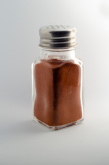 paprika in a spice container on a white background