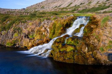 Iceland waterfall closeup view of the gods cliff with long exposure smooth motion of water in...