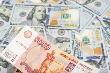 Fototapeta na wymiar 5000 rubles banknote lying on us dollar background, financial crisis concept