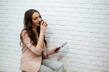 business woman holding tablet and drinking coffee © ostap_davydiak