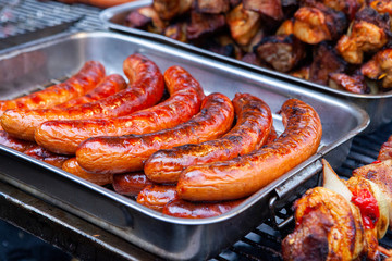 hot and heavily roasted sausages on the grill