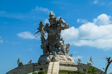 Obraz premium A close up on an ornated roof of Uluwatu temple, Bali Indonesia. It represents a monkey king fighting with smaller monkeys and other creatures. Hinduism. Traditional and cultural site