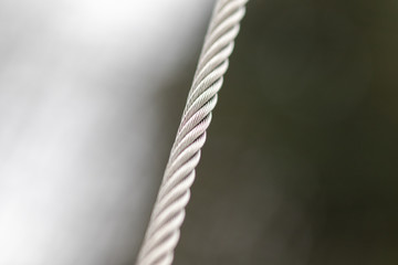 Stretched grey stable metal rope 