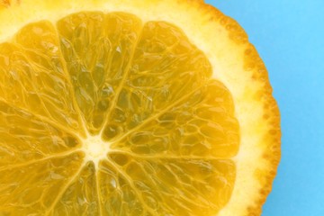 Orange slice macro.Juicy  orange texture  on a  blue background close-up.Fruit background. Orange...