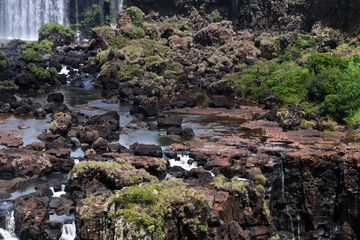 Iguazu roaring waterfalls against a jungle and gray sky