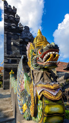 A colourful dragon wearing a crown at entrance gate to Tanah Lot temple on Bali, Indonesia. Traditional Hindu temple. Cultural and historical site. The dragon guards the entrance to the temple.