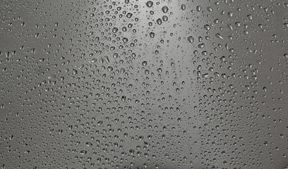 Drops of water on the glass, cloudy wether outside the window