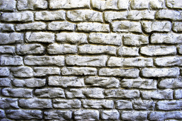Grey old worn brick wall texture background. Vintage effect. The wall is covered with white paint.
