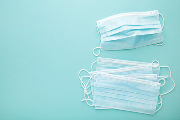 Medical masks on a blue background with copy space. Coronavirus