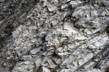 View of the sand and clay rock. Texture in black, gray, and white.