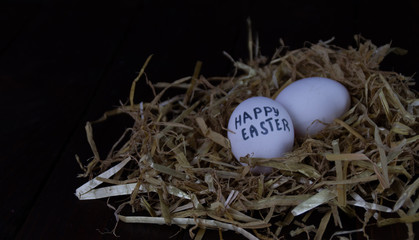 Nest with eggs on a dark background preparing for Easter. Happy easter