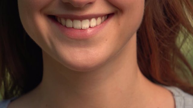 front view details caucasian young woman toothy smiling close up lower face lips and chin