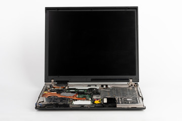 Laptop, removed keyboard, hard disk drive, CD drive, battery . Visible CPU fan, main board with CPU and graphics card