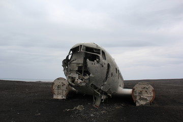 abandoned old plane at volcanic beach