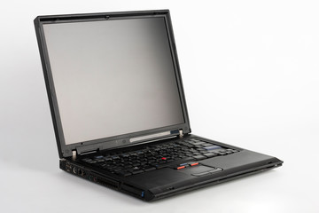 Old laptop on white background, which was produced in 2005, outer cover reinforced titanium, metal...