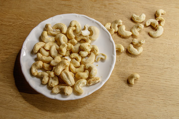 Cashew nuts. The cashew tree is a tropical evergreen tree that produces the cashew seed and the cashew apple.