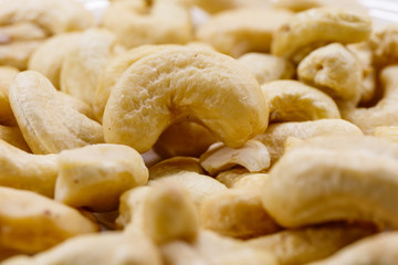 Cashew nuts. The cashew tree is a tropical evergreen tree that produces the cashew seed and the cashew apple.