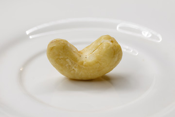 Cashew nuts. The cashew tree is a tropical evergreen tree that produces the cashew seed and the cashew apple.