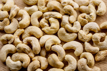 Cashew nuts. The cashew tree is a tropical evergreen tree that produces the cashew seed and the cashew apple.