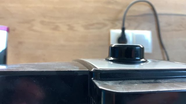 Close up of steam rising up from the electric waffle iron in the kitchen 
