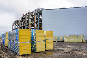 sandwich wall panels in piles, ready for wall mounting