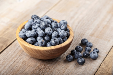 Freshly picked blueberries in wooden bowl. Blueberry antioxidant.