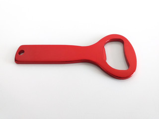 Horizontal view of red bottle opener isolated on white background. Close up of Beer opener.