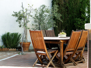 chairs and table in a corner of patio