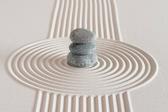 Japanese zen garden with stone in textured white sand