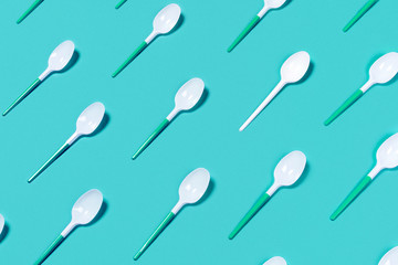 Plastic spoons on color background.