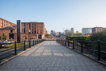 The Albert Dock area of Liverpool just after sunrise, with low sun and long shadows
